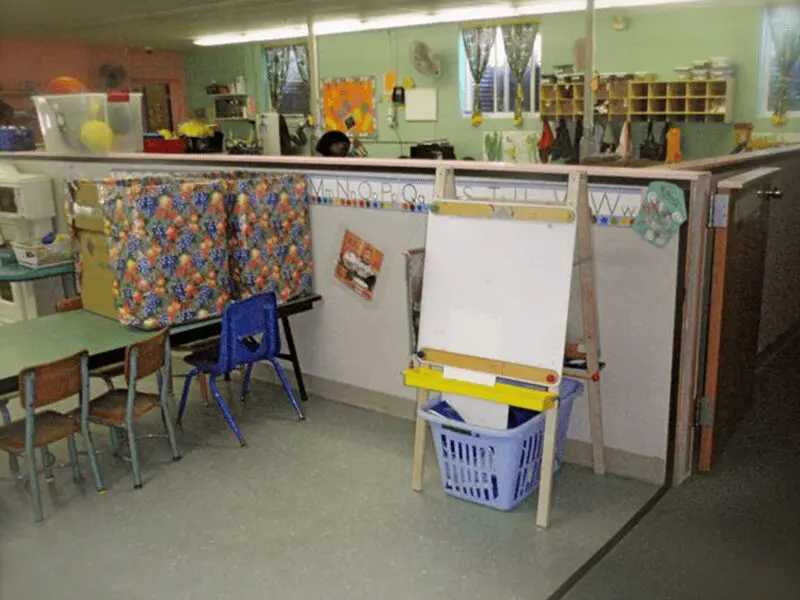 A classroom with chairs, desks and a whiteboard.