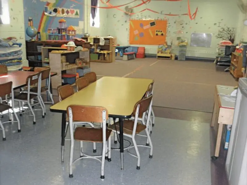 A classroom with tables and chairs in it