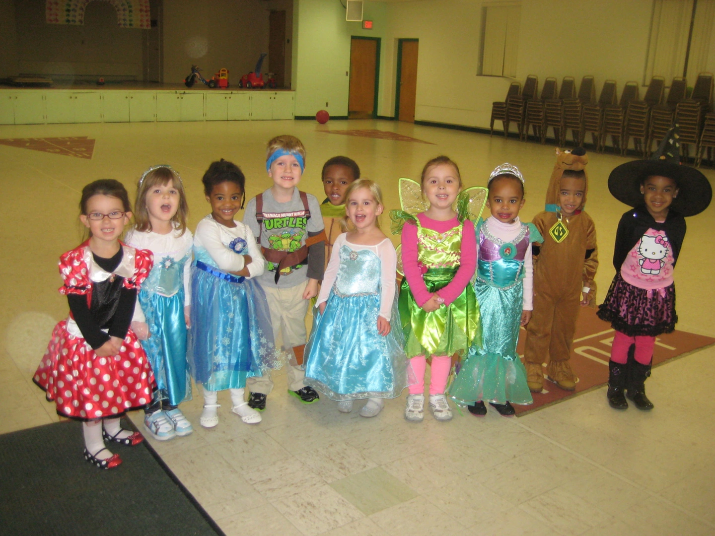 A group of children dressed up in costumes.