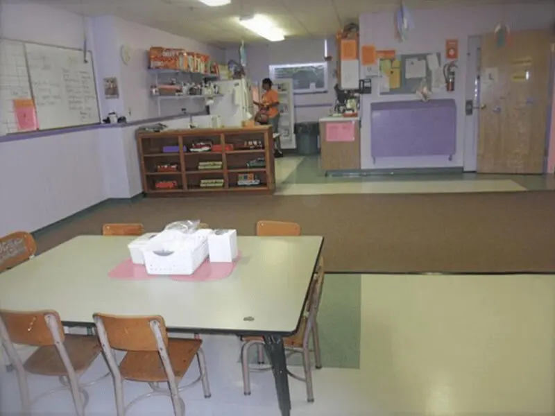 A kitchen with a table and chairs in it