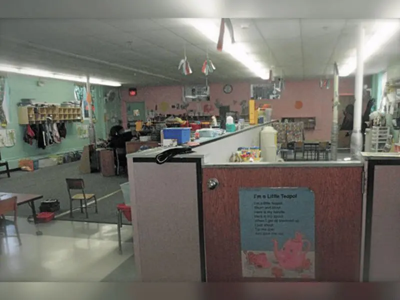 A kitchen with a counter and chairs in it